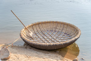 Raffia coracle moored to stone Raffia coracle moored to stone